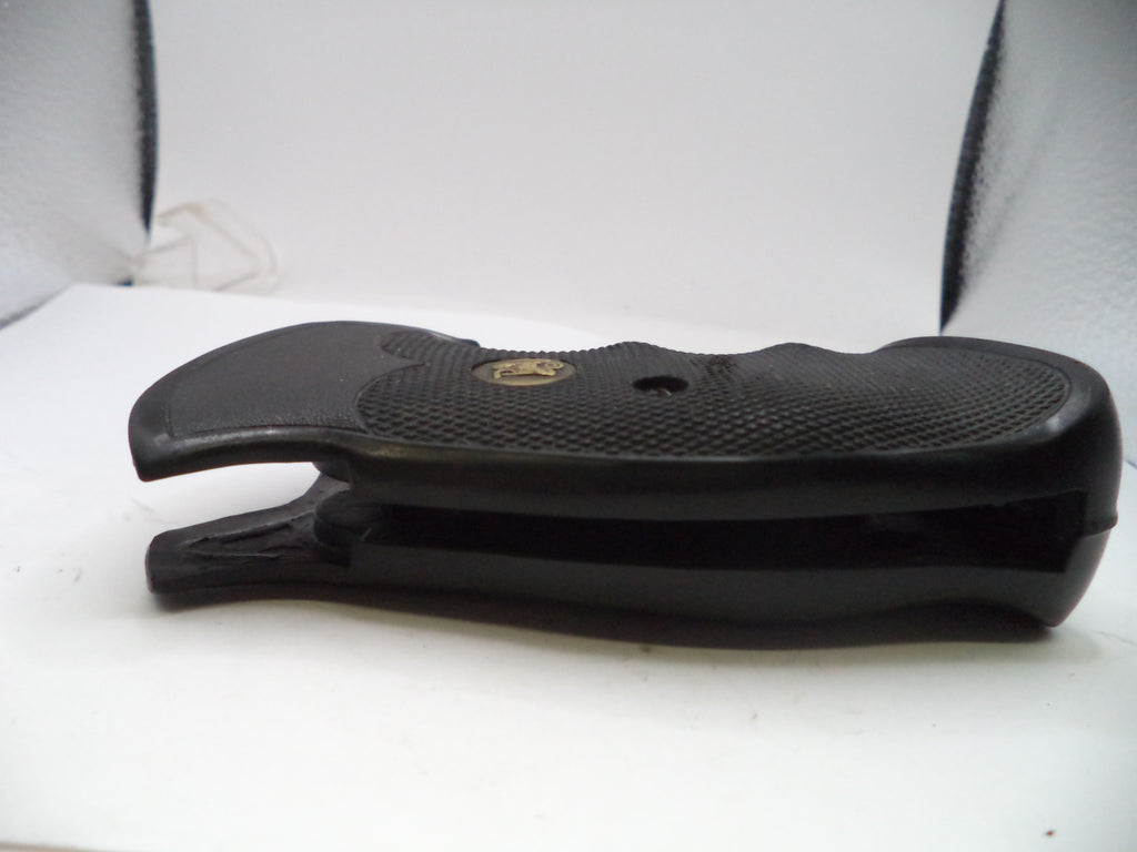 Black rubber gun stock on a white surface