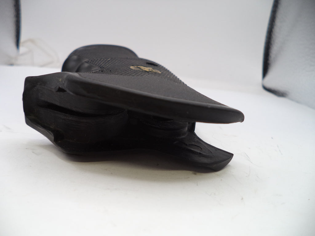 Black sandal with a visible brand logo on a white surface