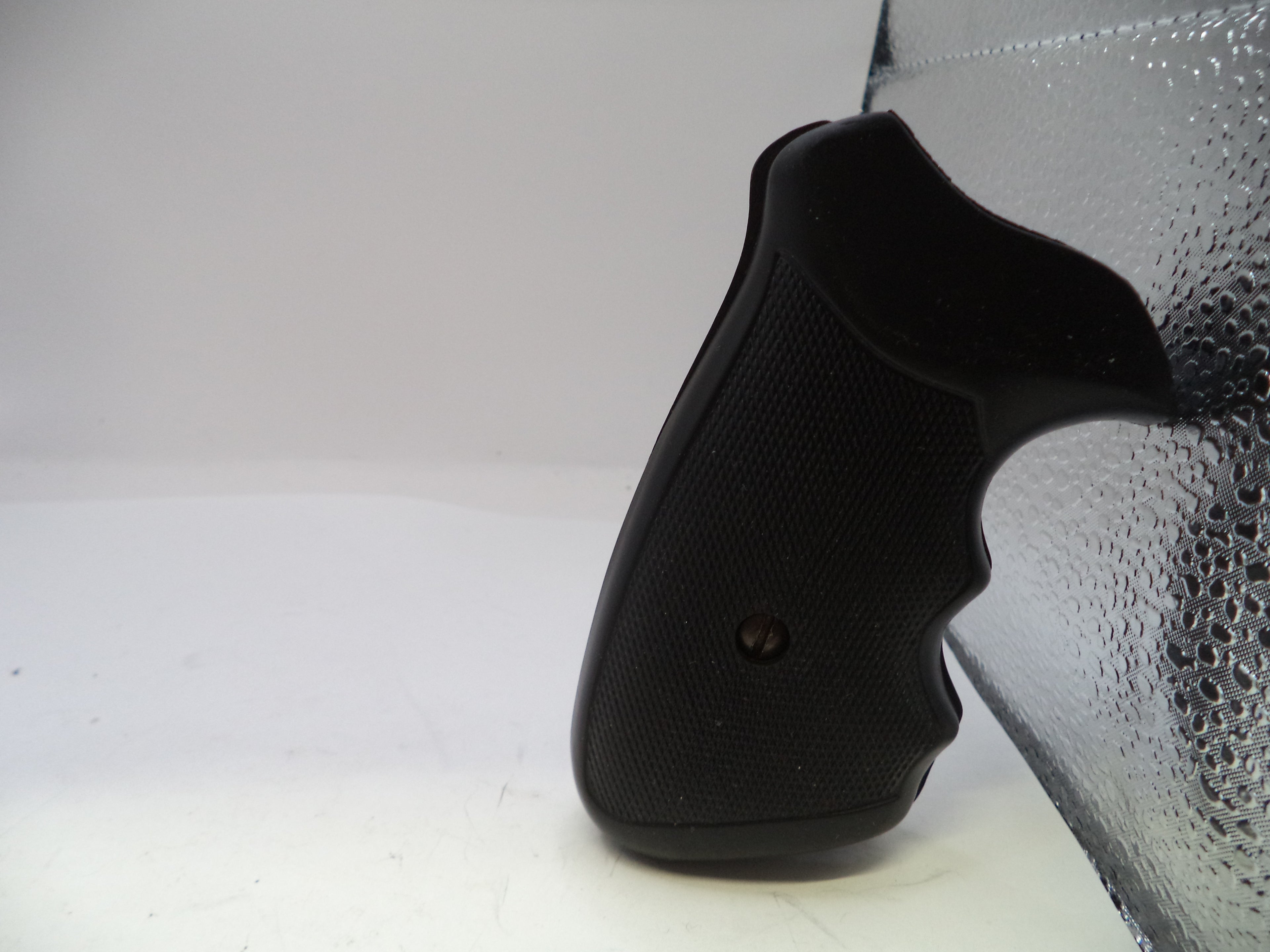 Black gun grip on a white background