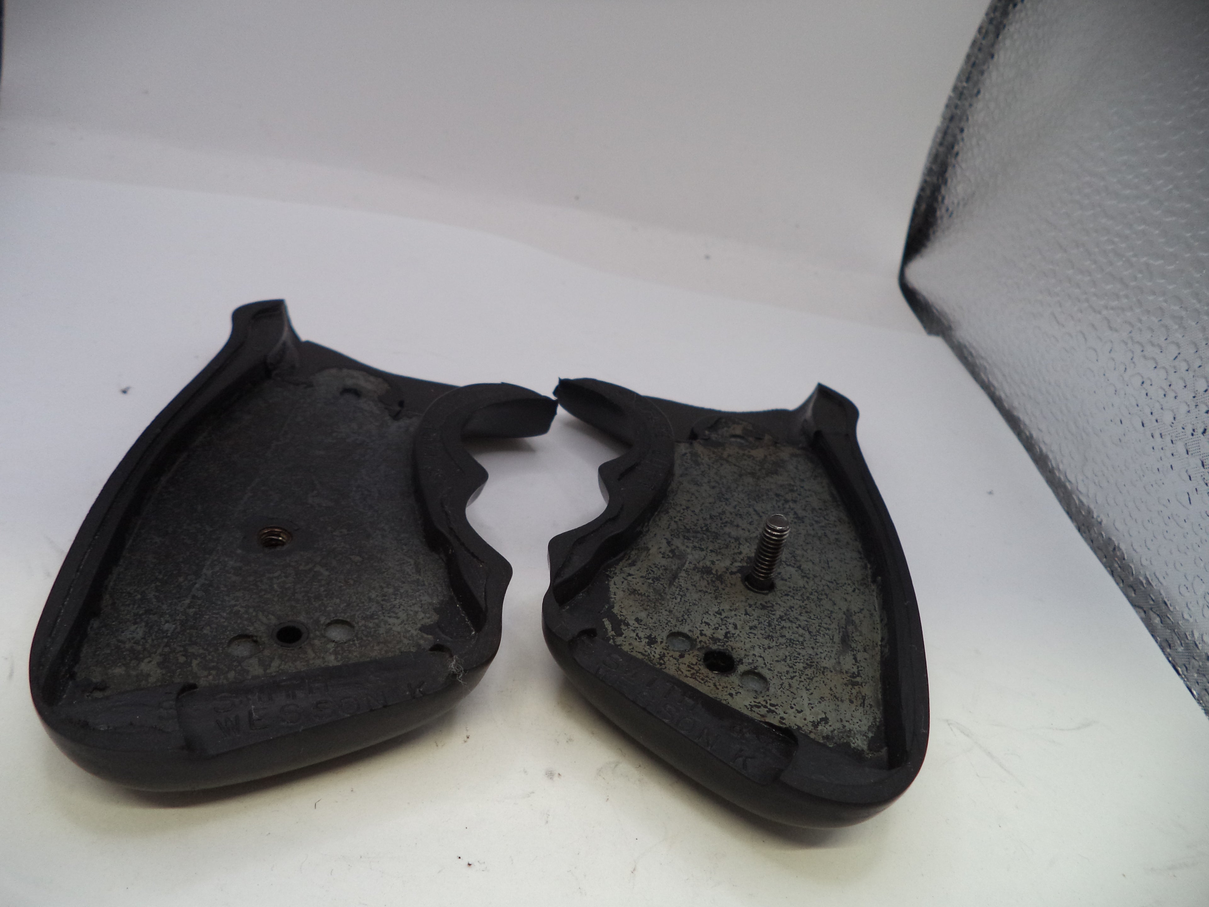 Two black rubber gaskets on a white surface