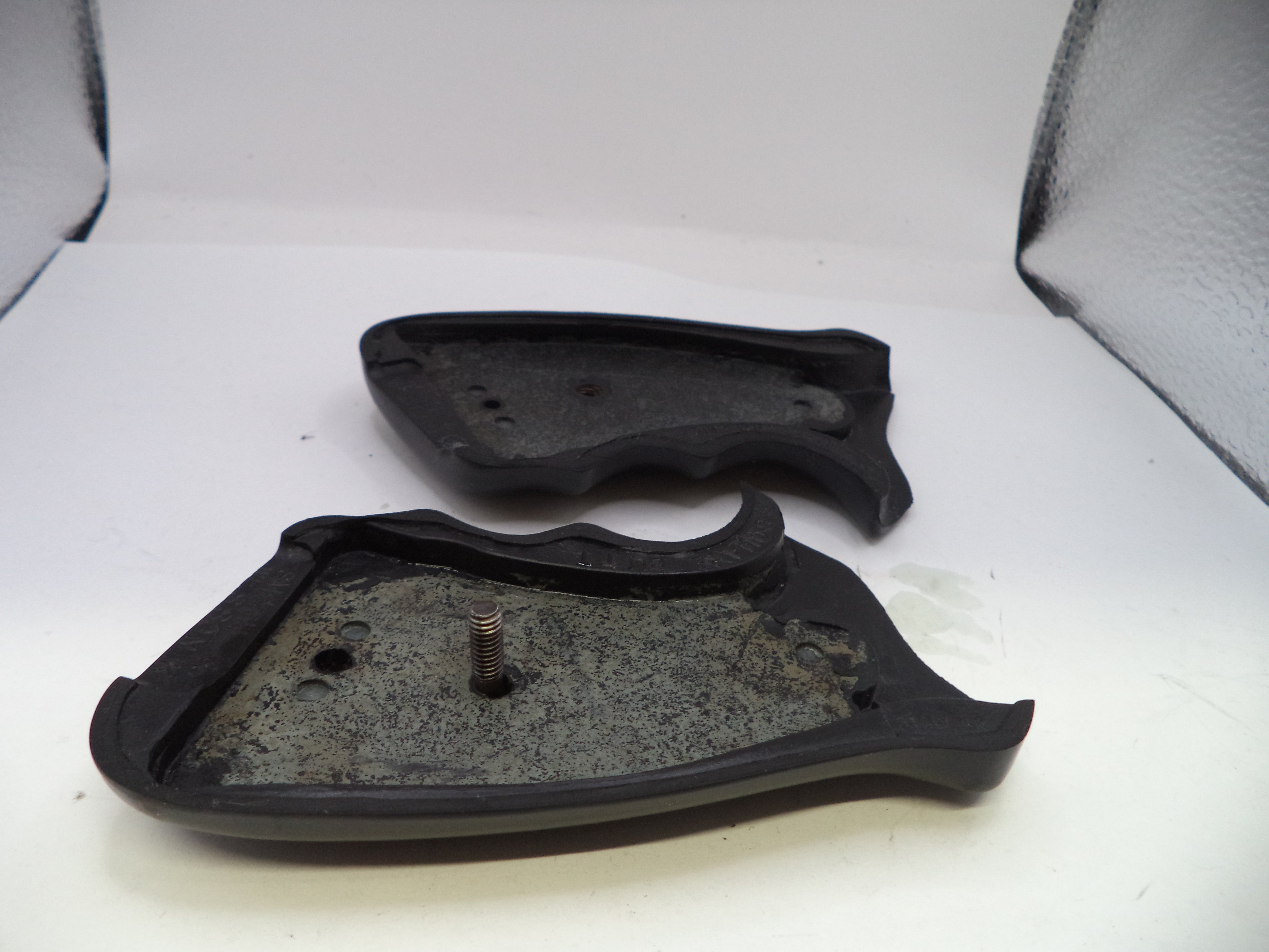 Two black rubber components on a white background