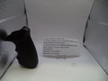 Black rubber grip on a stand with text in front of a textured white background