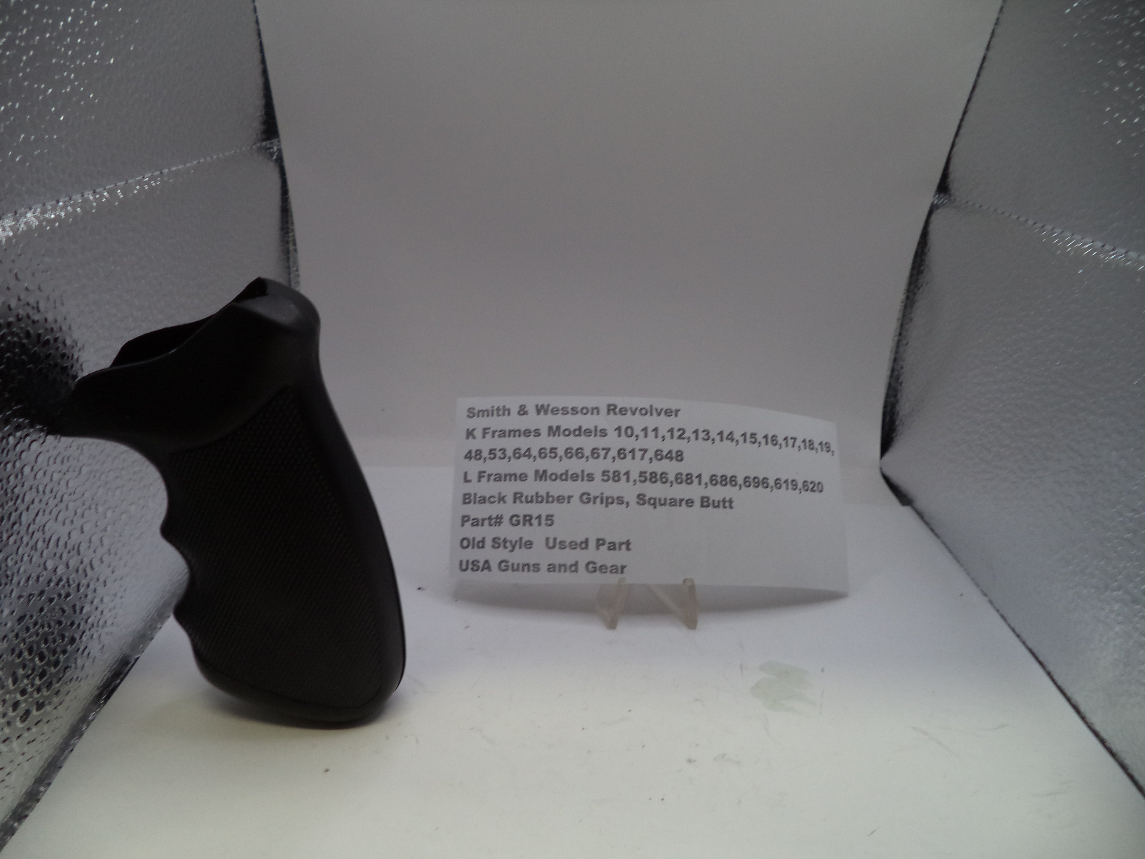 Black rubber grip on a stand with text in front of a textured white background