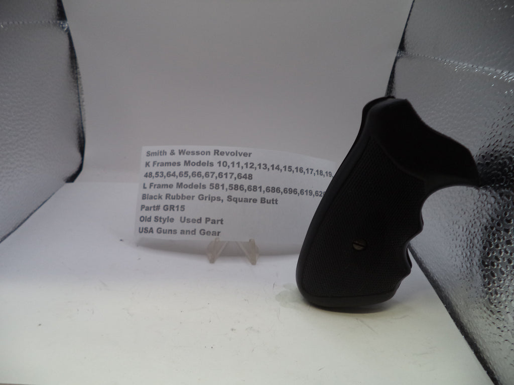 Black revolver grip on a white surface with text in the background