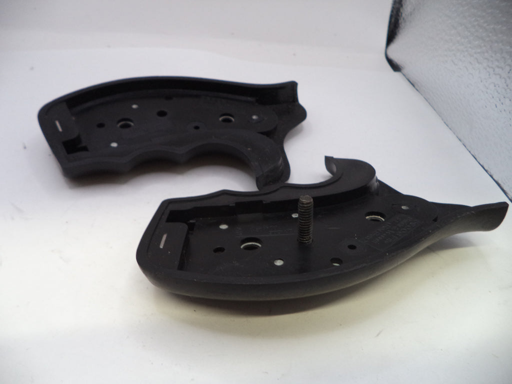 Two black plastic components on a white surface