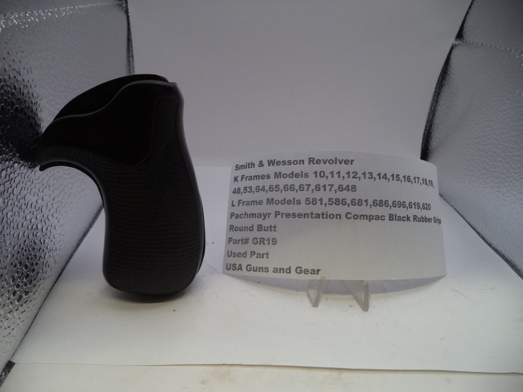 Black revolver grip and information card on a white surface