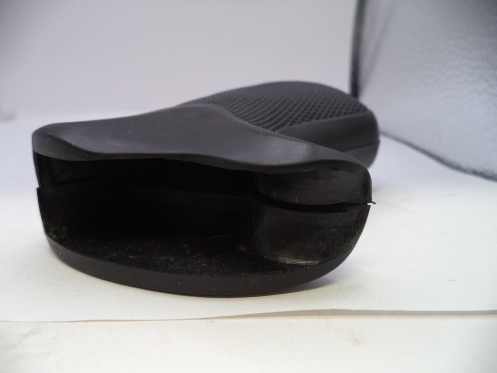 Black shoe insert on a white surface