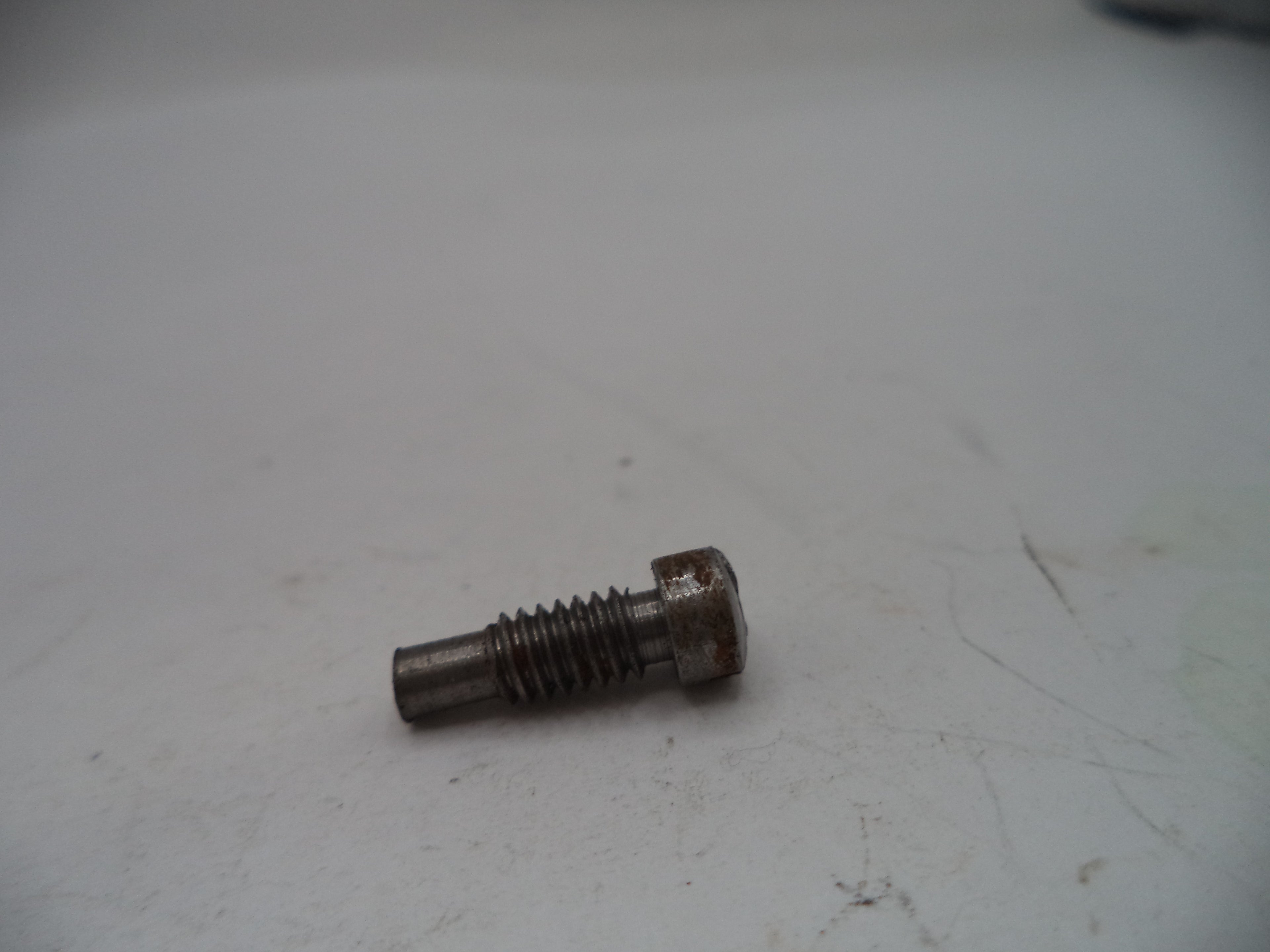 Rust-covered bolt on a white surface