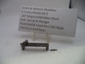 Smith & Wesson revolver parts on a white background with a label.