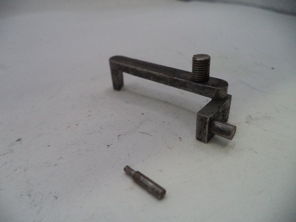 Metal toggle bolt on a white surface