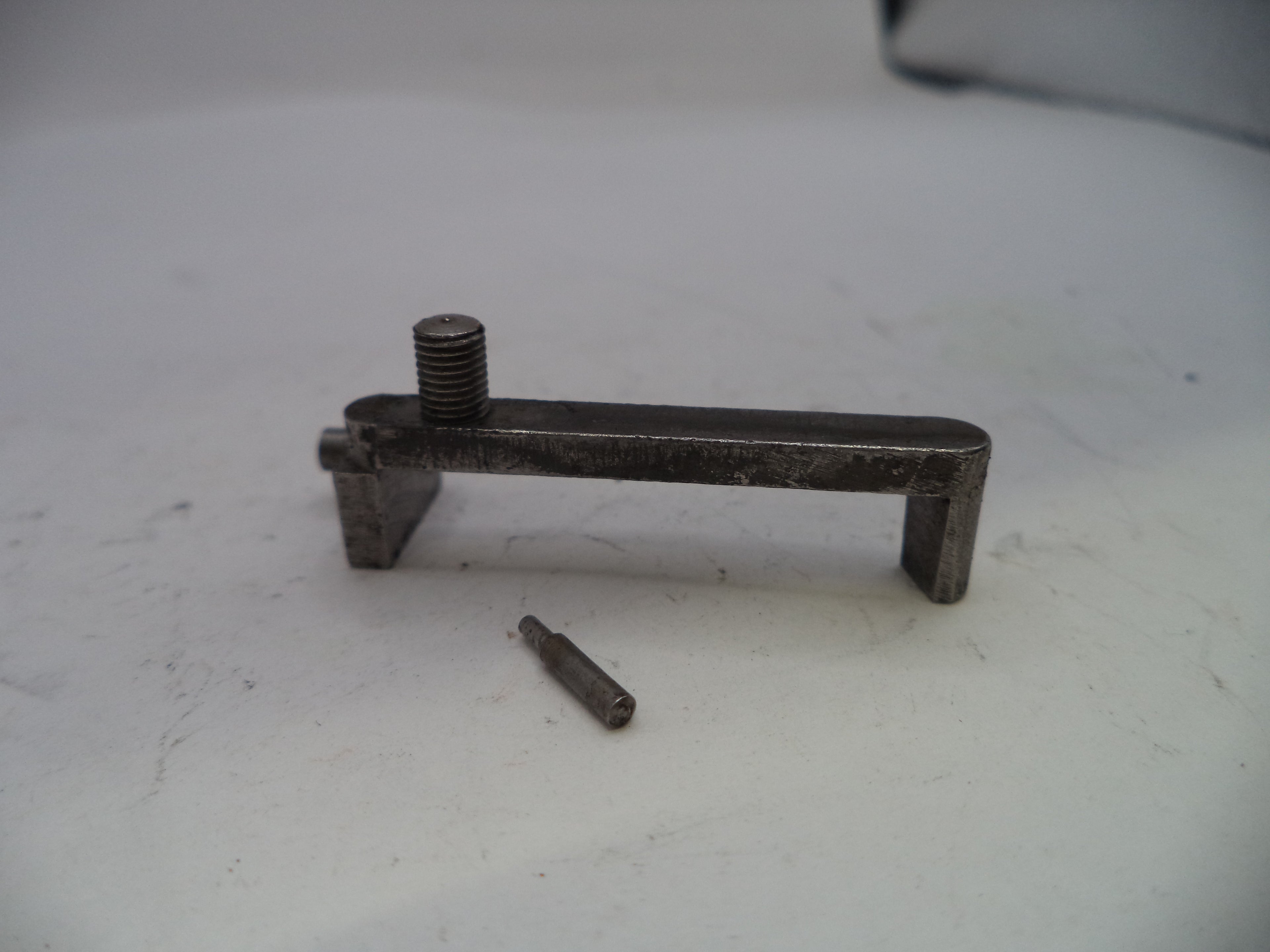 Metal tool or component on a white surface