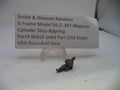 Smith & Wesson revolver part with descriptive card on a white background