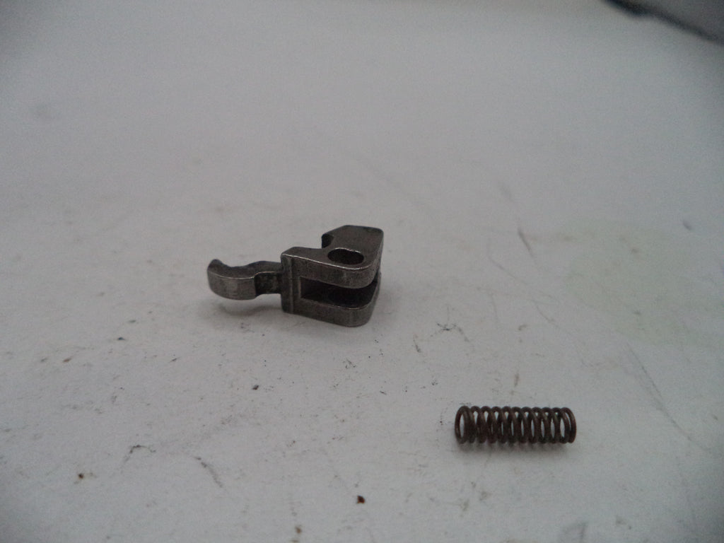 Metal clip and spring on a white surface