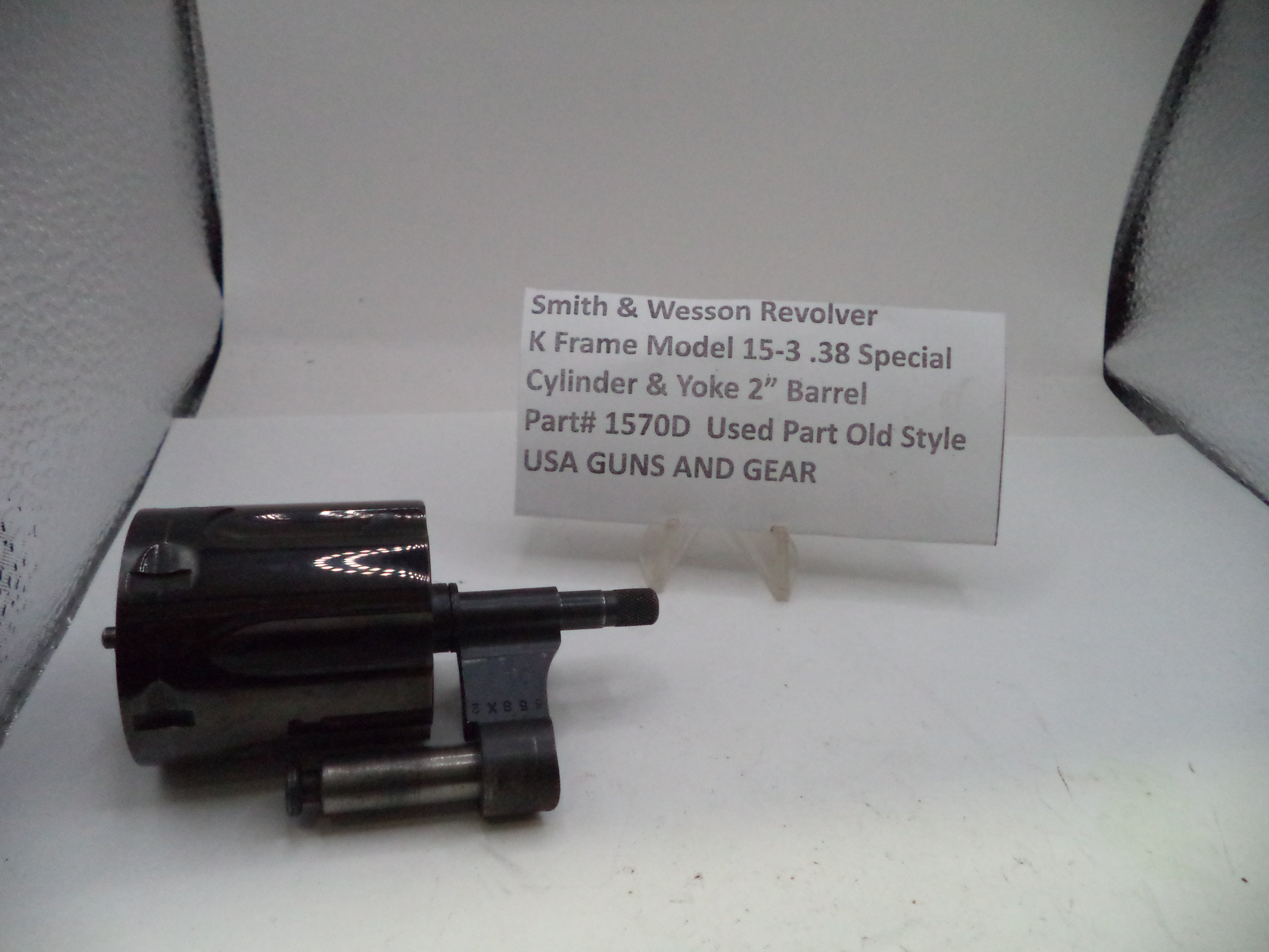 Smith & Wesson revolver part on a white background with a label