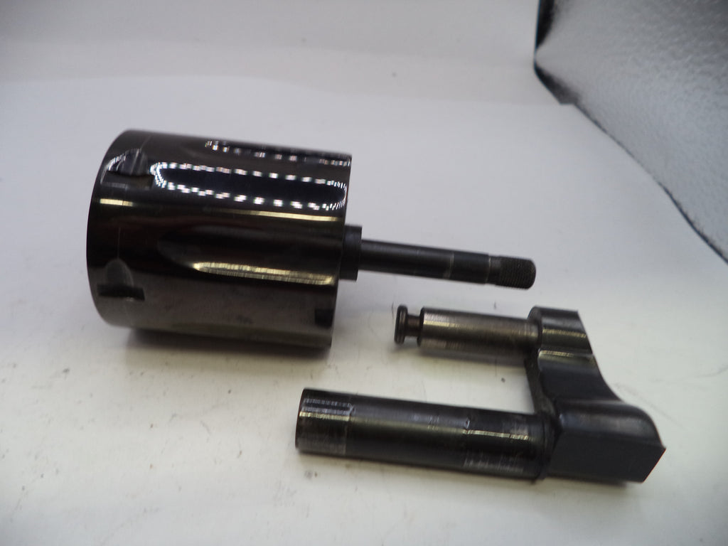 Two black cylindrical metal components on a white surface