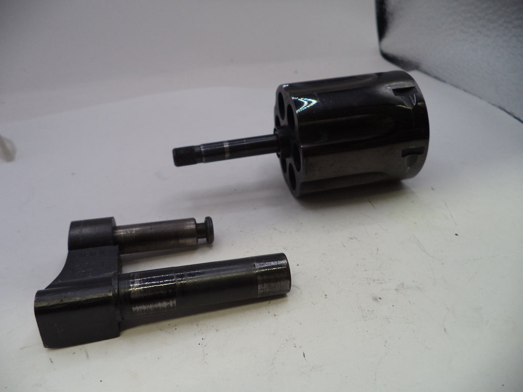 Two black mechanical components on a white surface