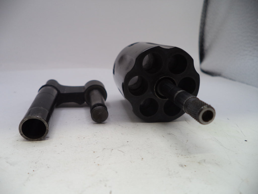 Two black metal components on a white surface
