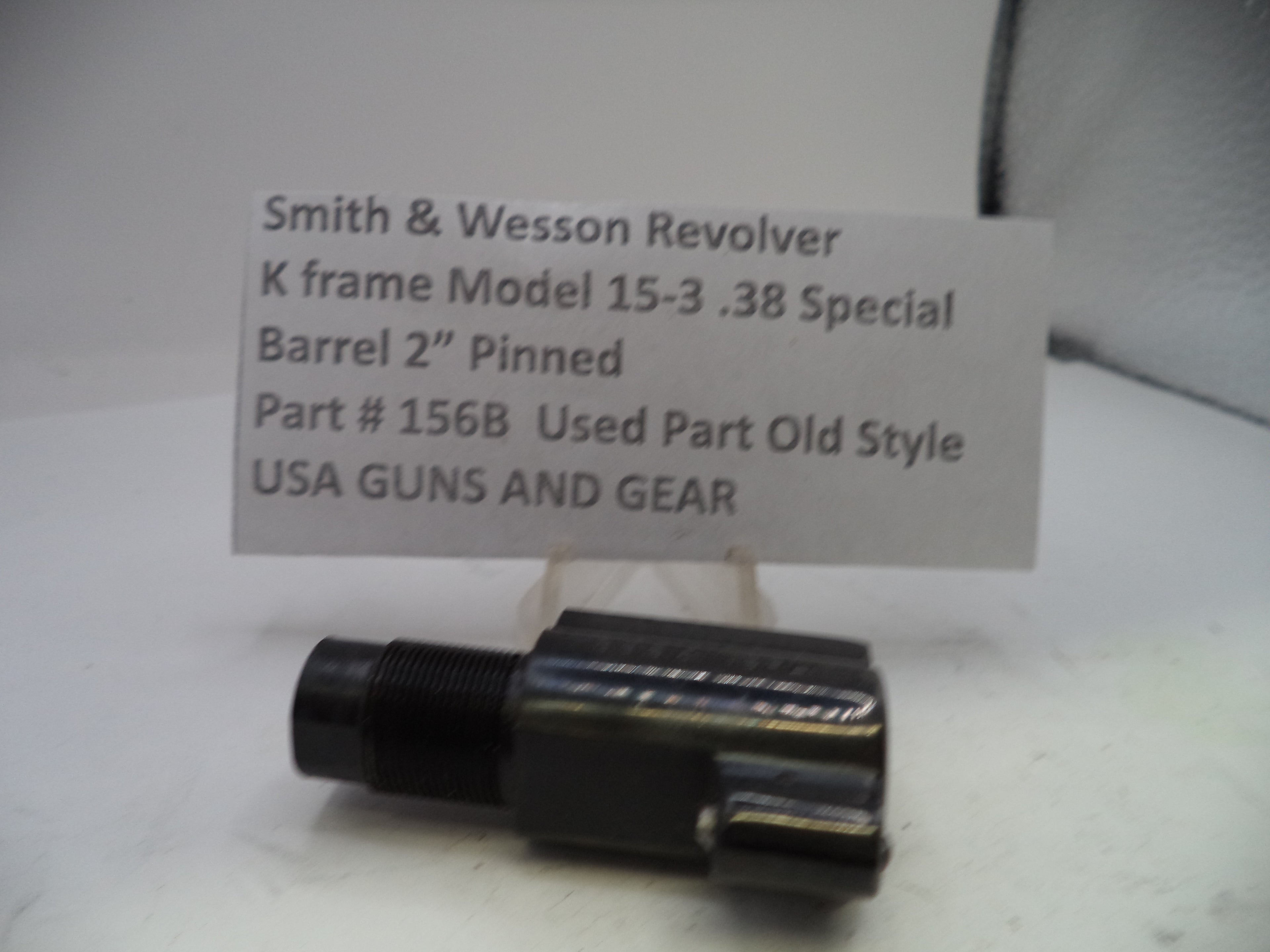 Smith & Wesson revolver barrel part with a label on a white background