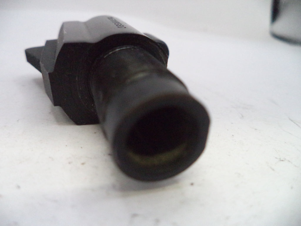 Black mechanical component on a white surface