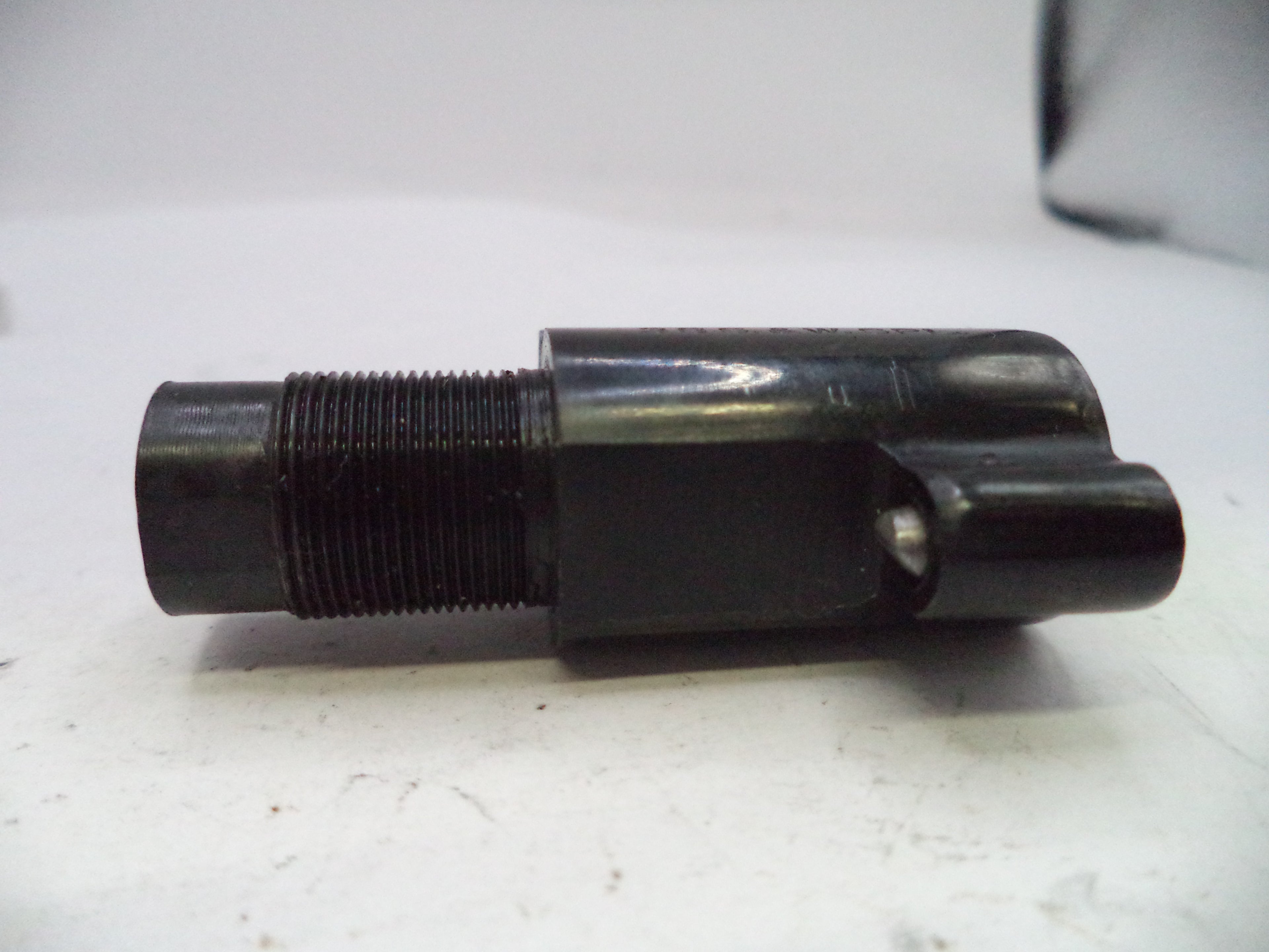 Black mechanical component on a white surface