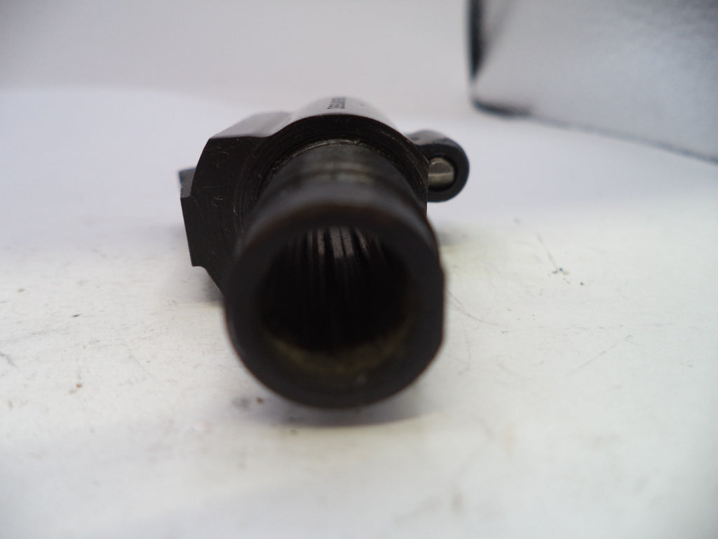 Black mechanical component on a white surface