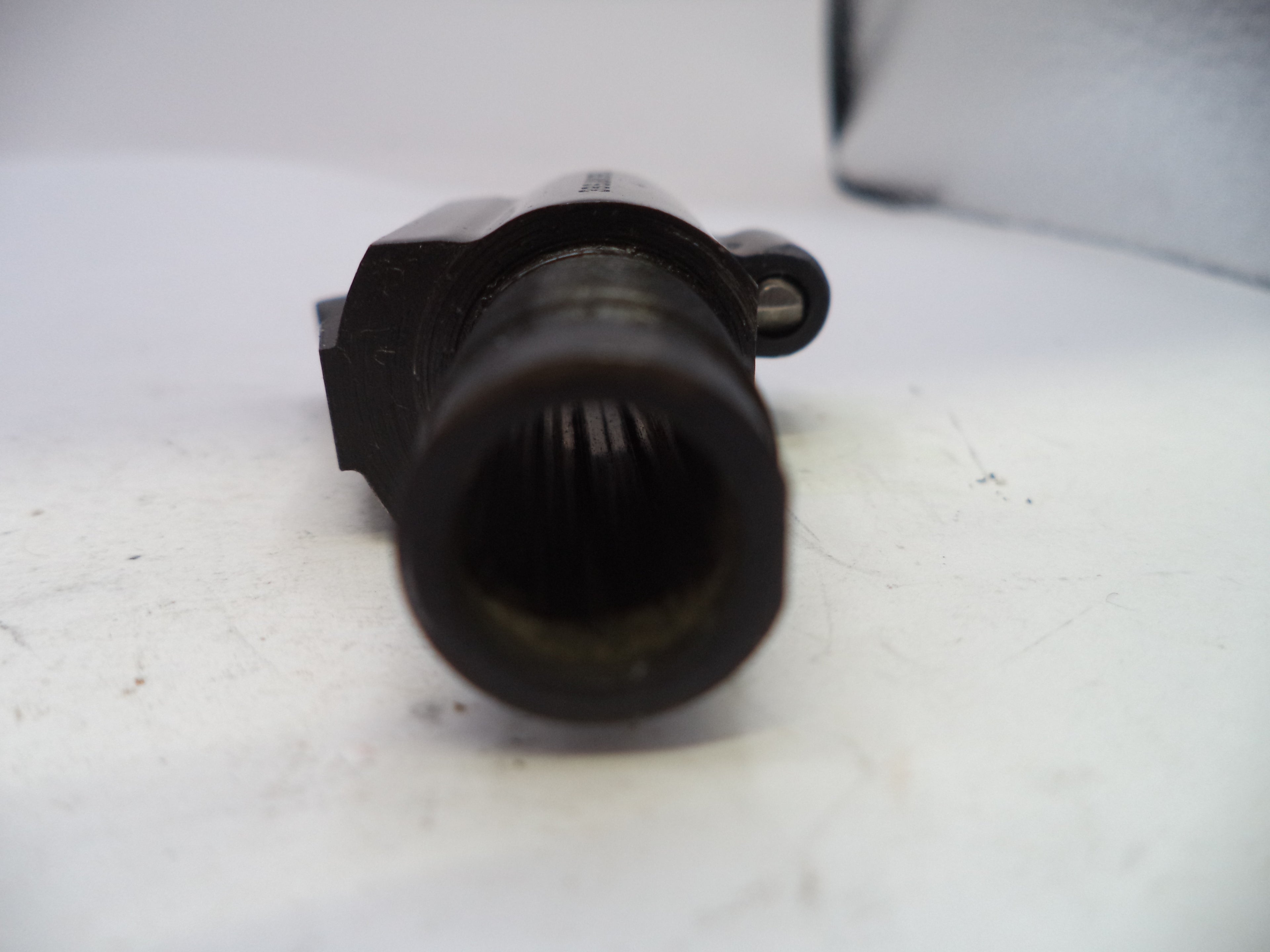 Black mechanical component on a white surface