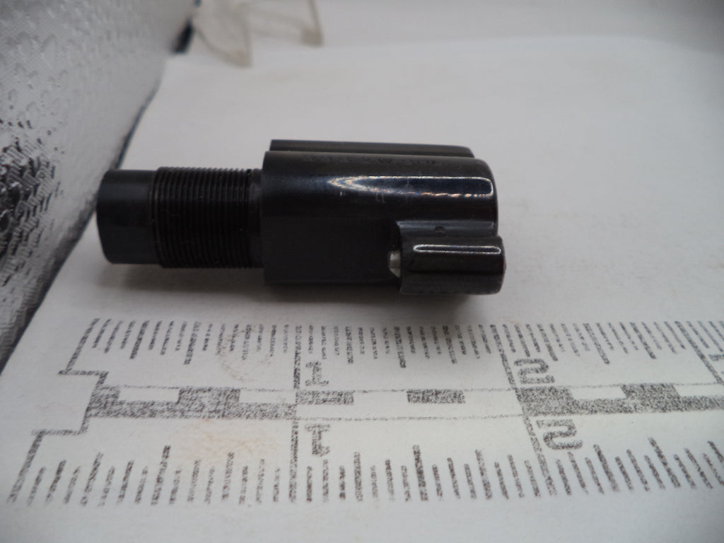 Black cylindrical object on a printed paper background