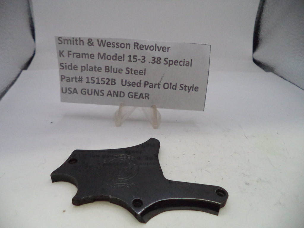 Black side plate for a Smith & Wesson revolver on a white background with a label.