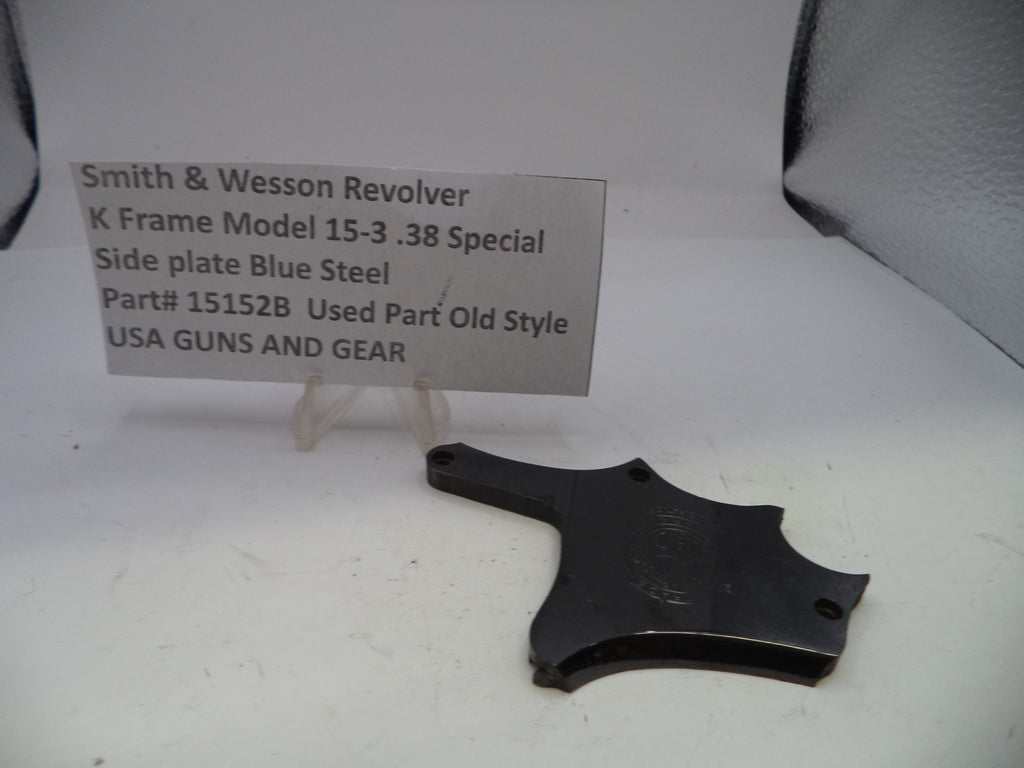 Smith & Wesson revolver side plate on a white surface with a label
