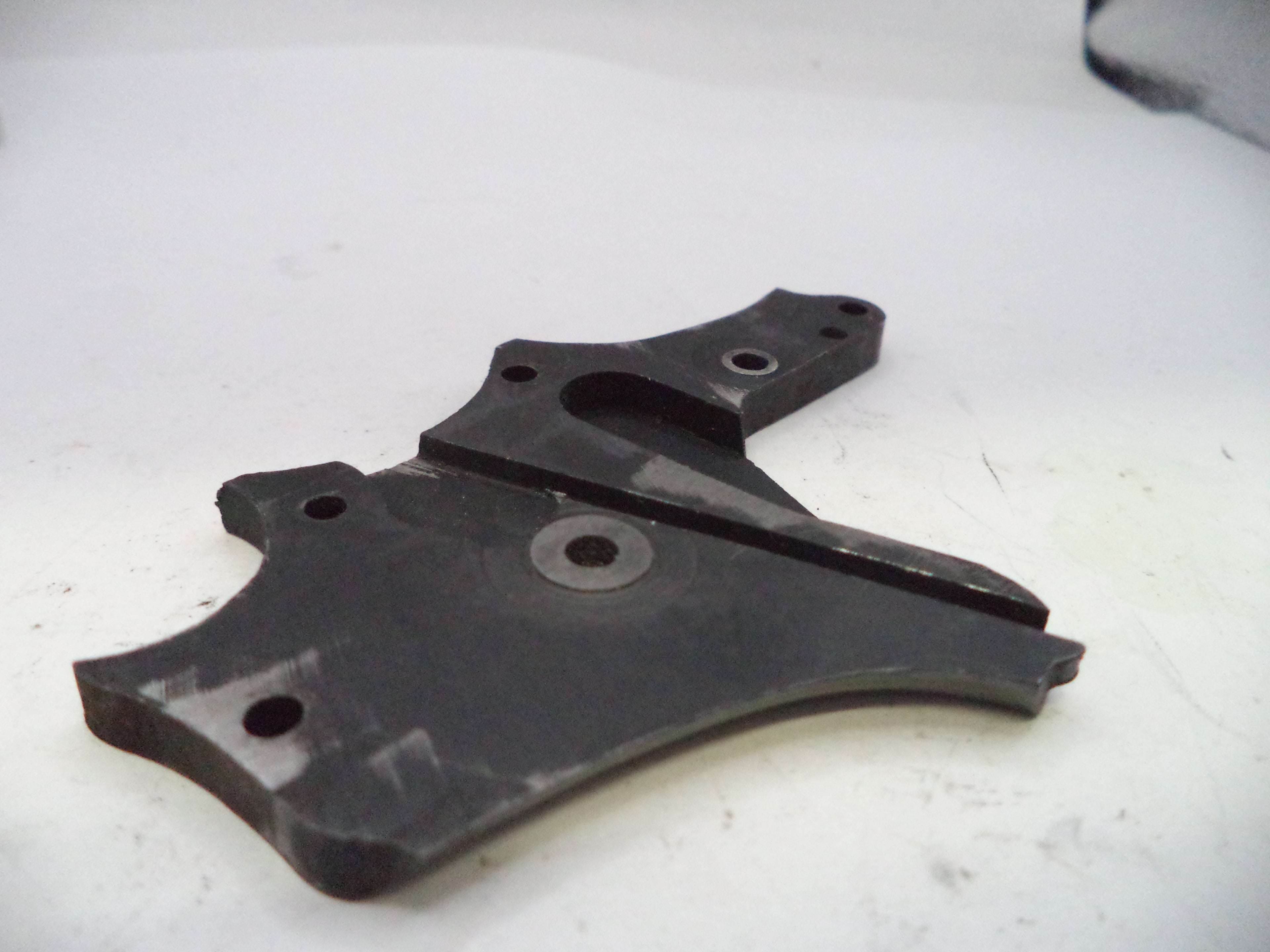 Black metal bracket on a white surface