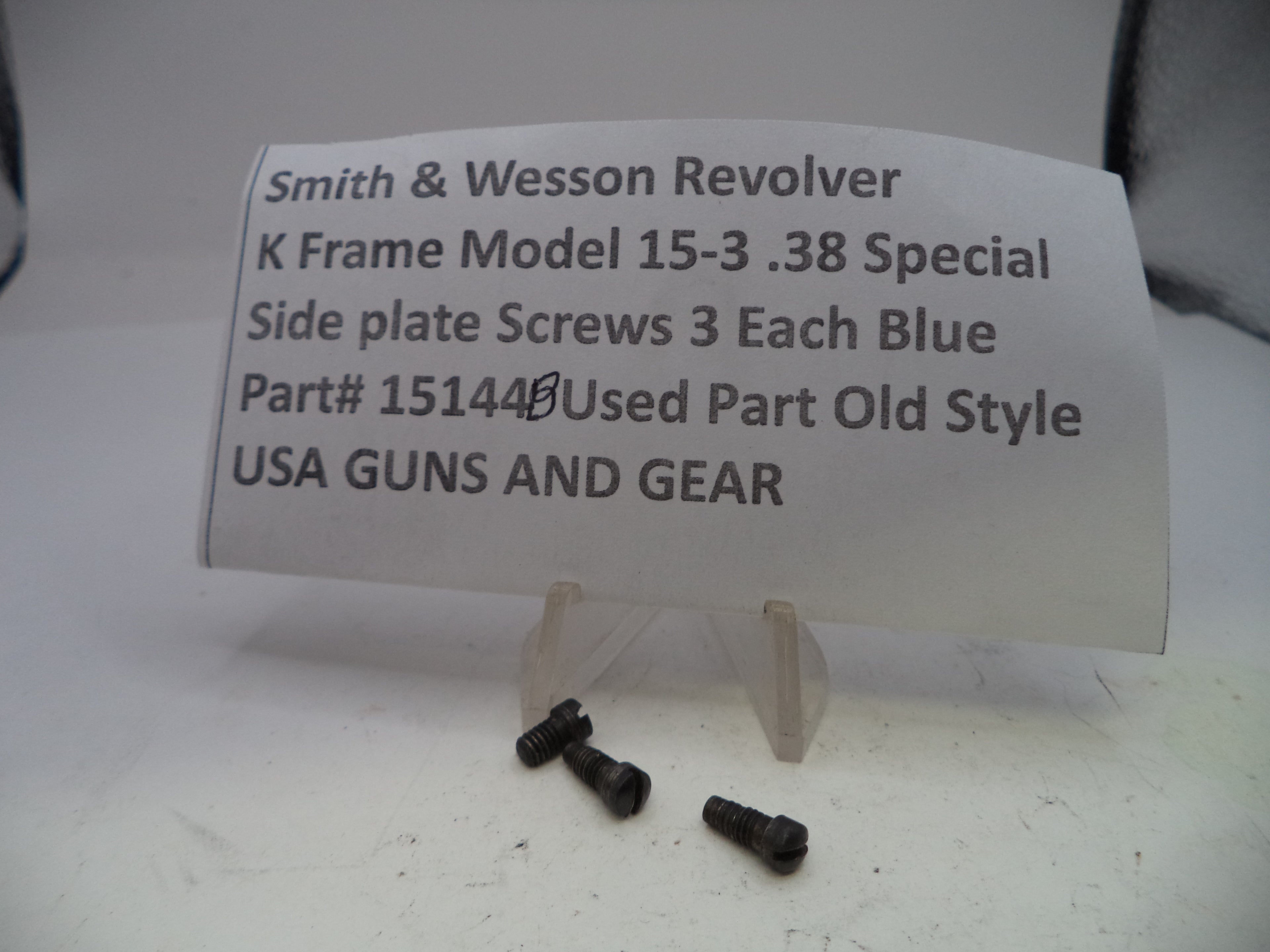 Black screws on a white card with text about Smith & Wesson Revolver on a light gray background