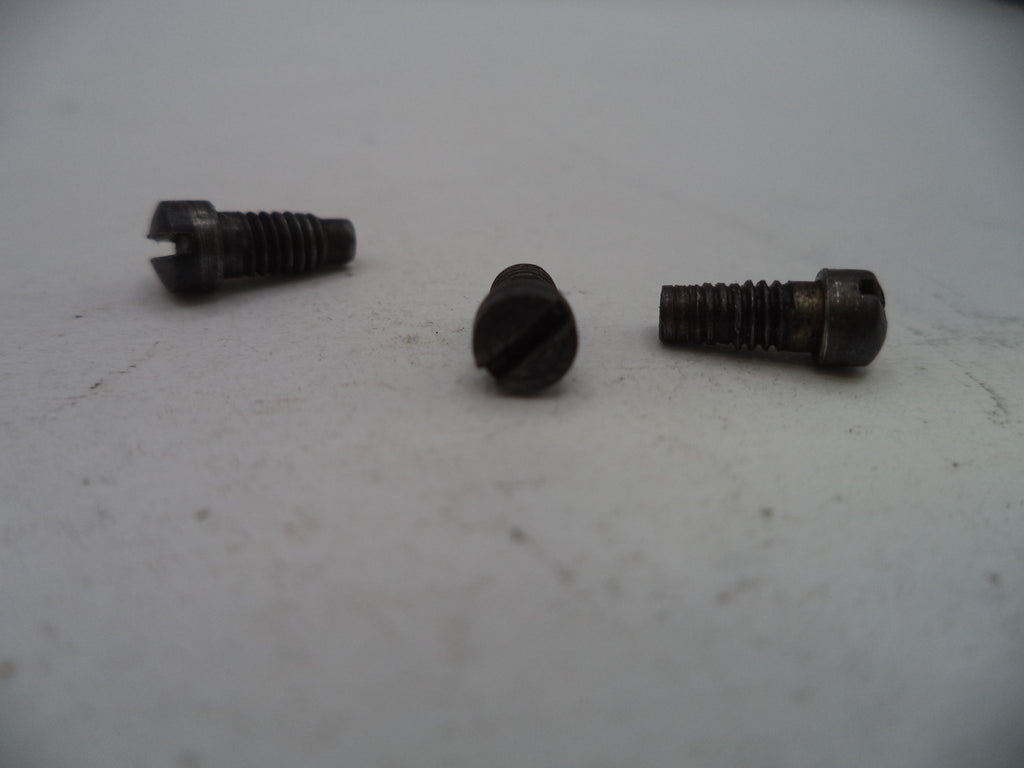 Three metal screws on a light gray surface