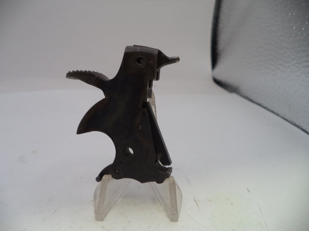 Black metal component on a clear stand against a white background