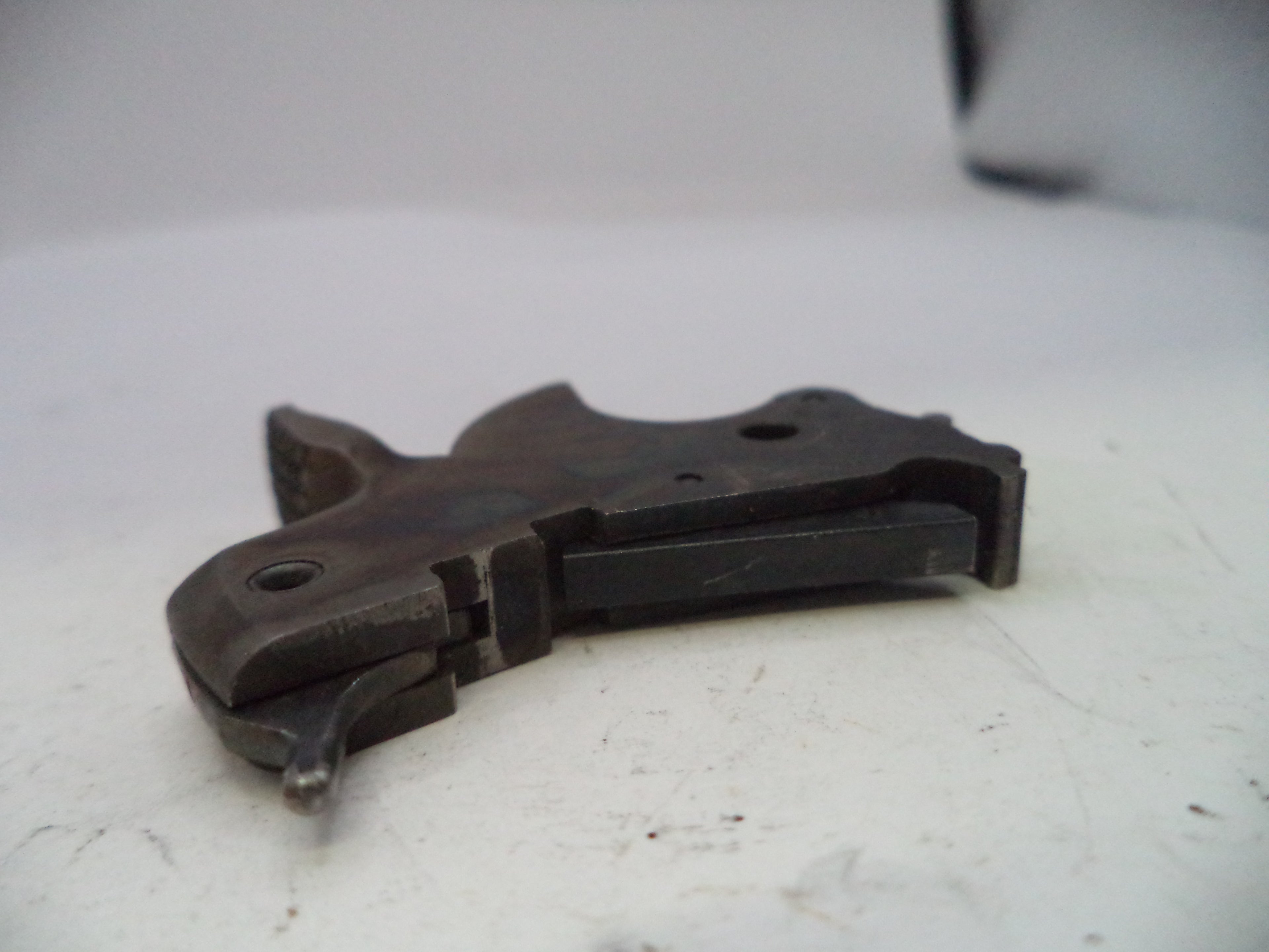 Black metal component on a white surface