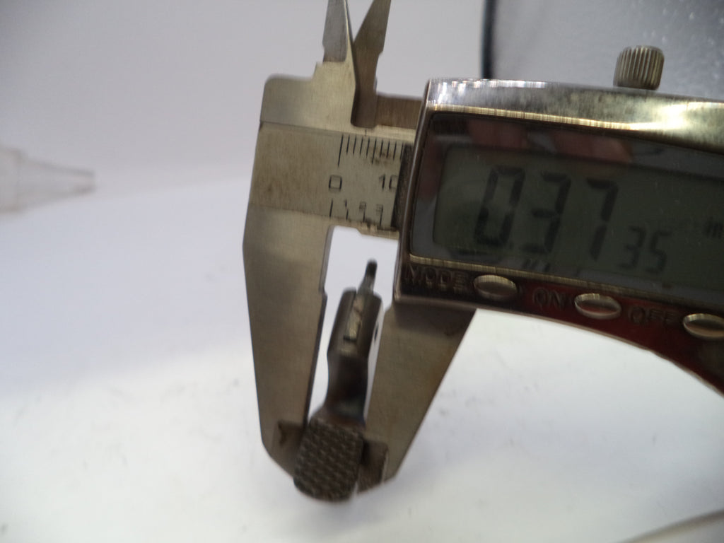 Digital caliper measuring a small object with a white background