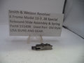 Smith & Wesson revolver slide assembly and spring on a white background with a label.