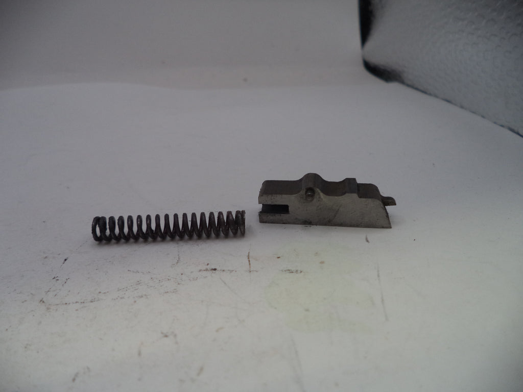 Metal spring and mechanical component on a white surface