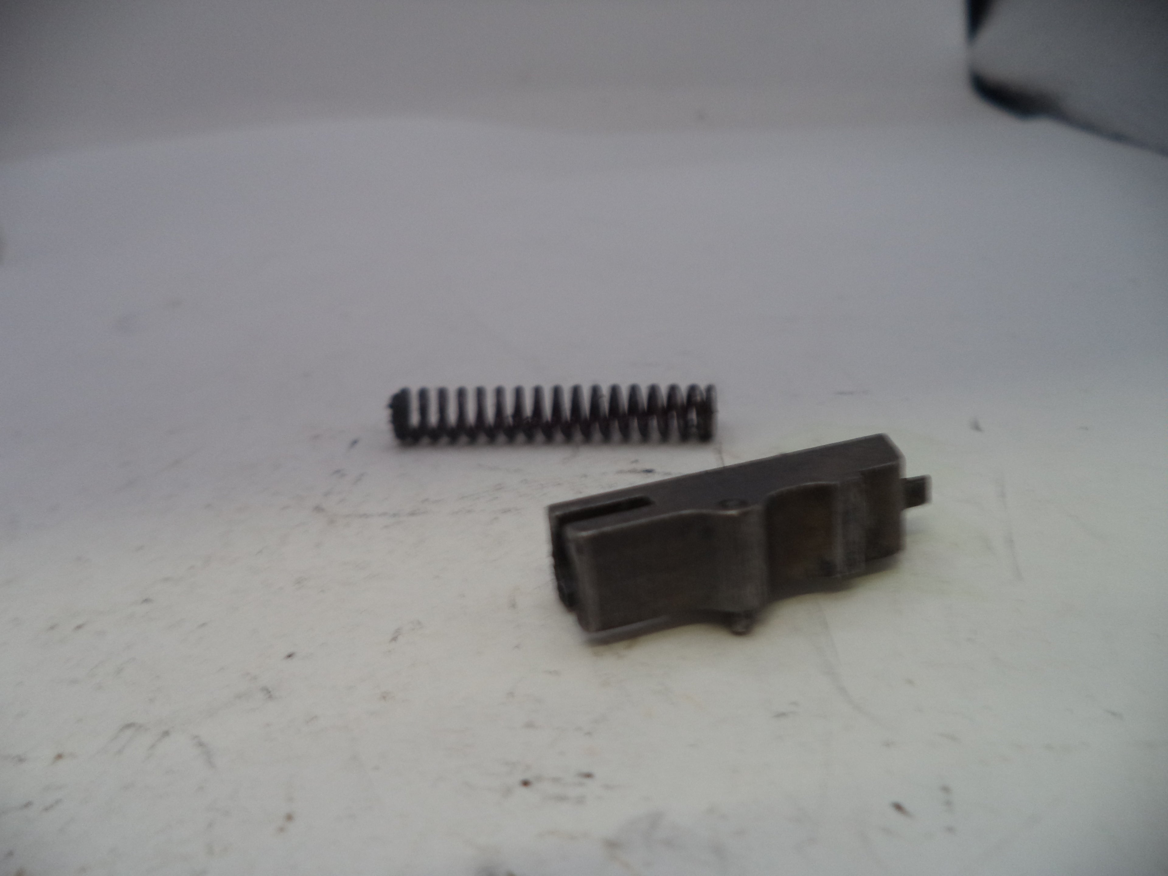 Two black plastic components on a white surface