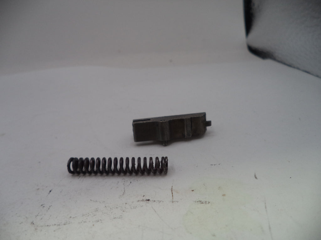Two metal components on a white surface