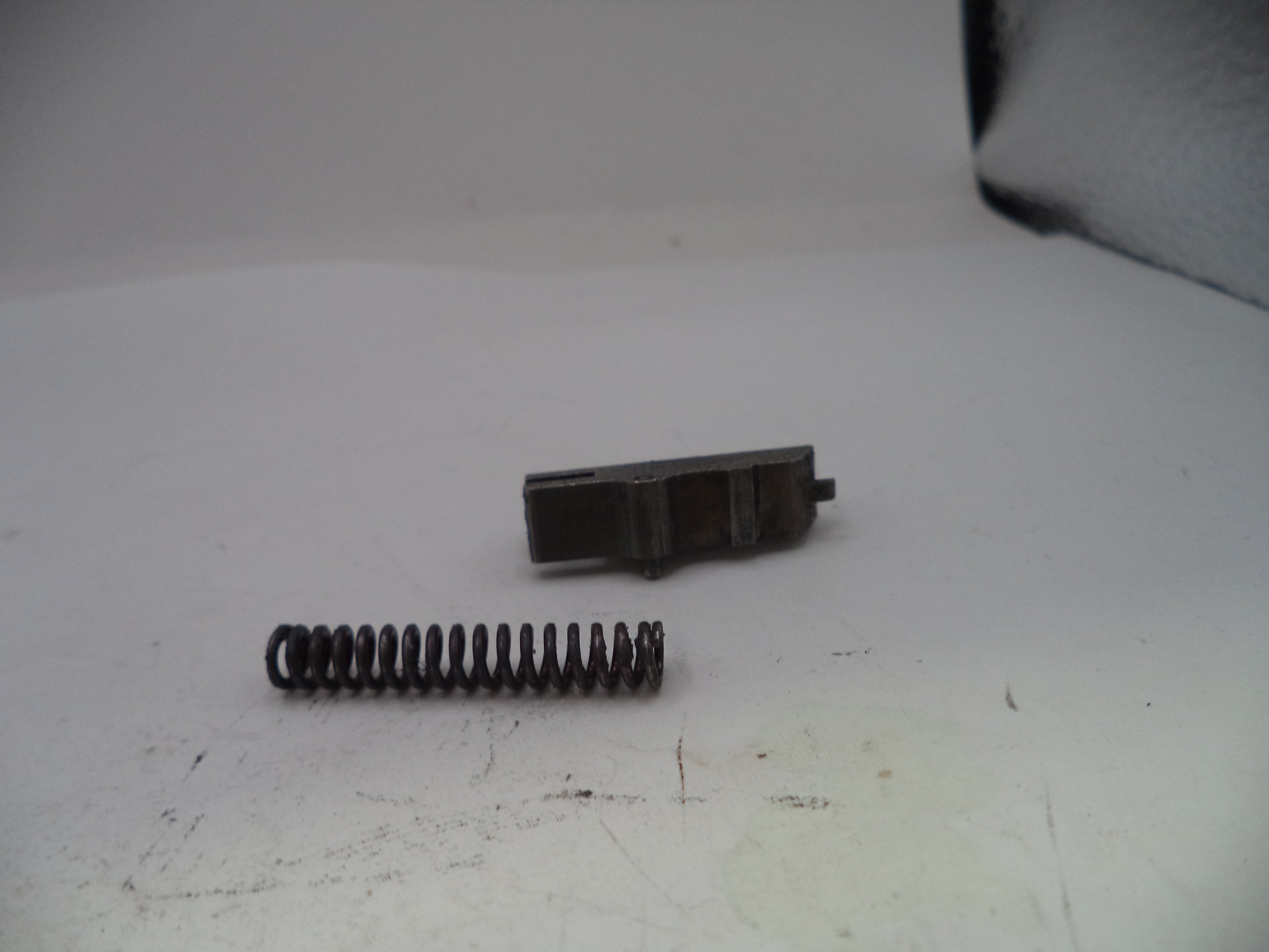 Two metal components on a white surface