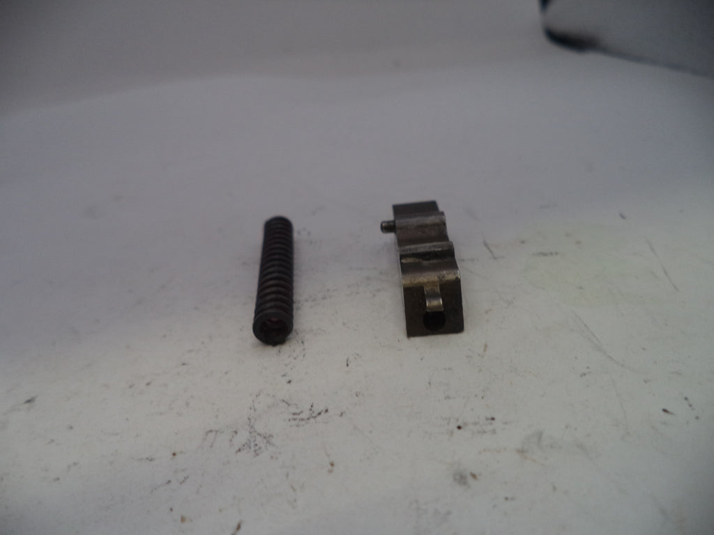 Two metal components on a white surface
