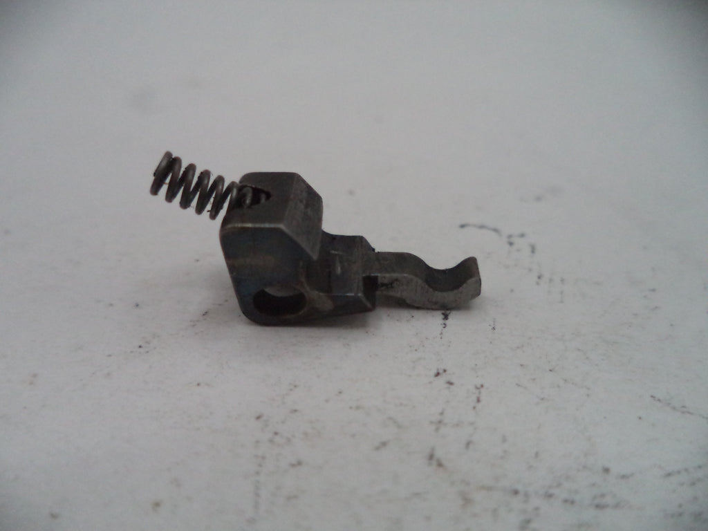Metal spring and mechanical component on a light gray surface