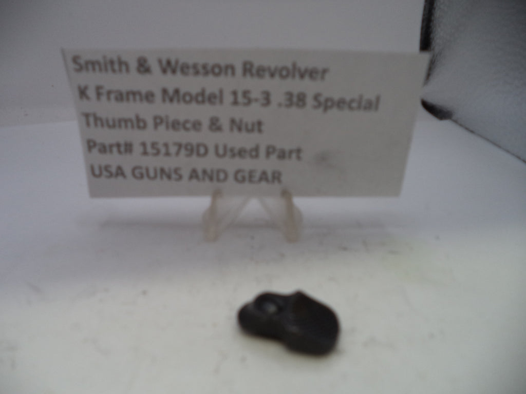 Small black object on a white surface with a sign about a Smith & Wesson revolver part.