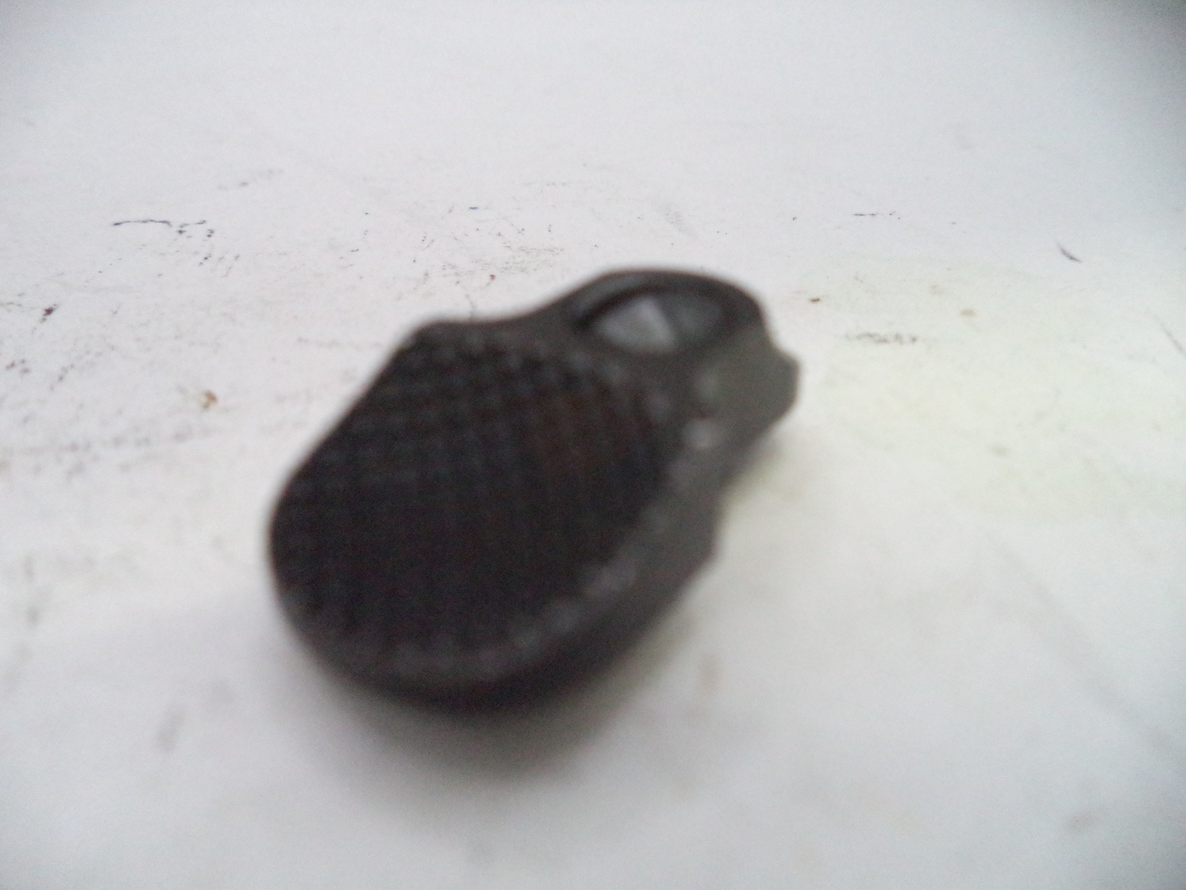 Black textured object on a white surface