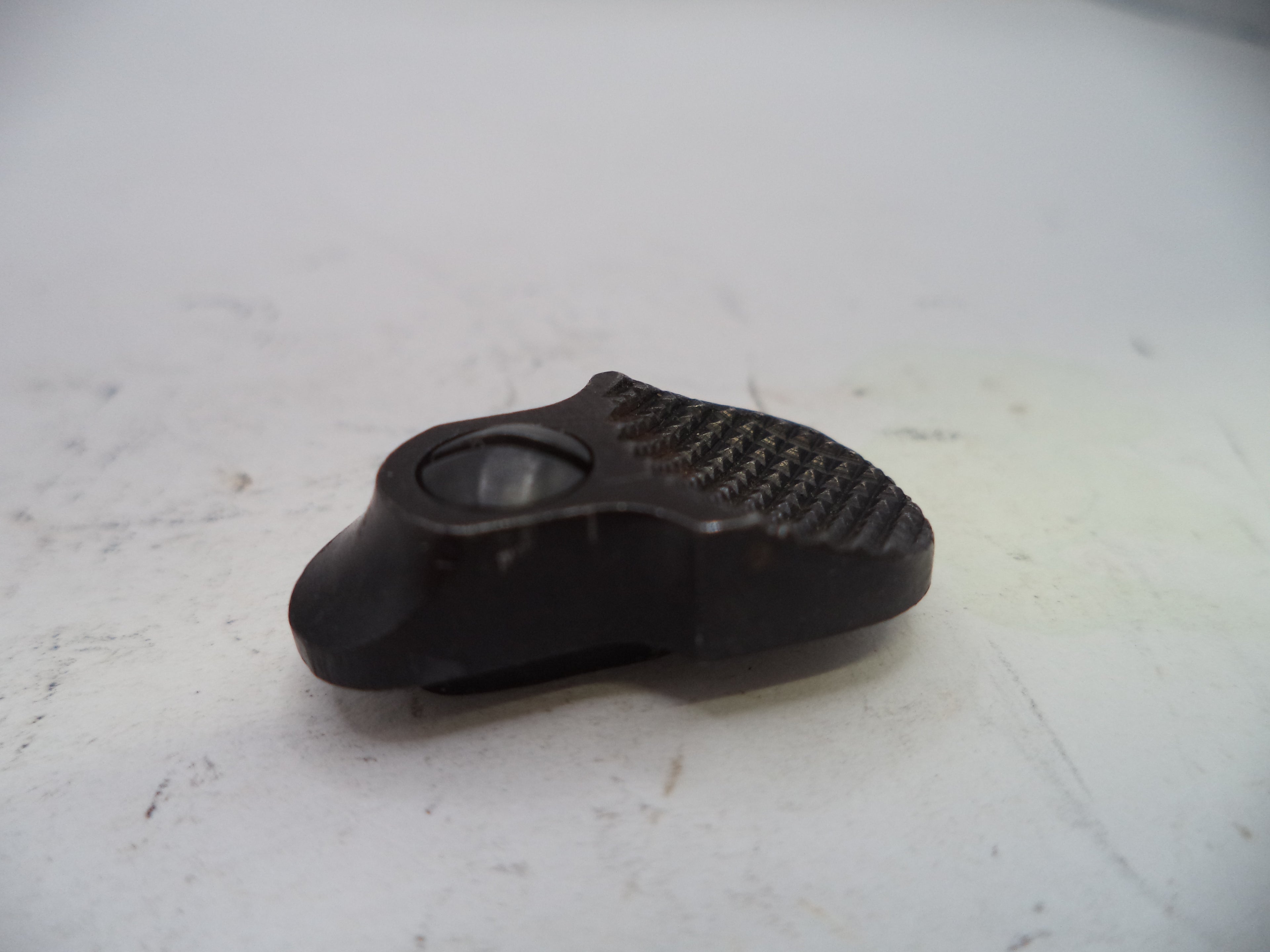 Black plastic component on a white surface