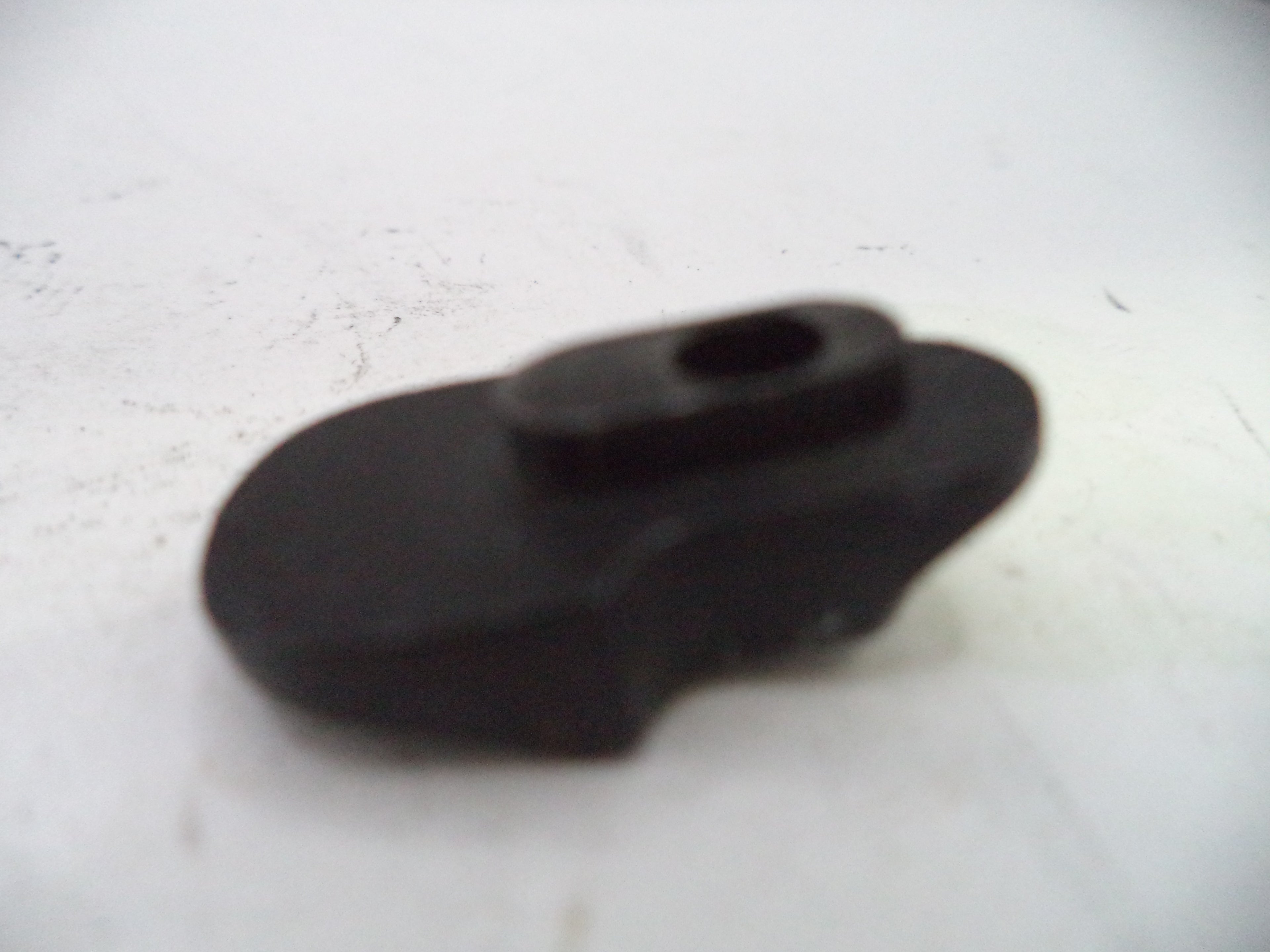 Black plastic component on a white background