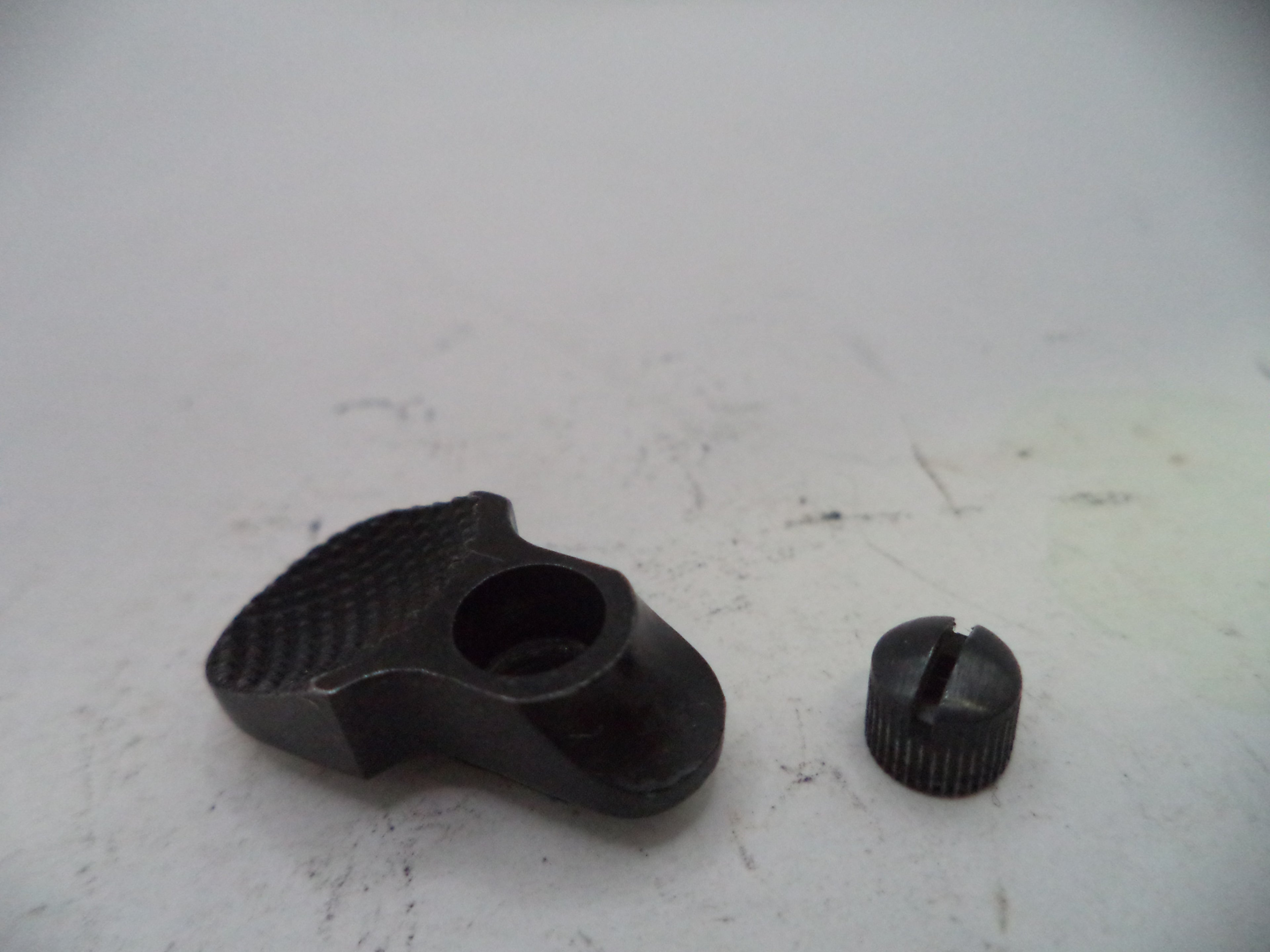 Two black mechanical parts on a white surface