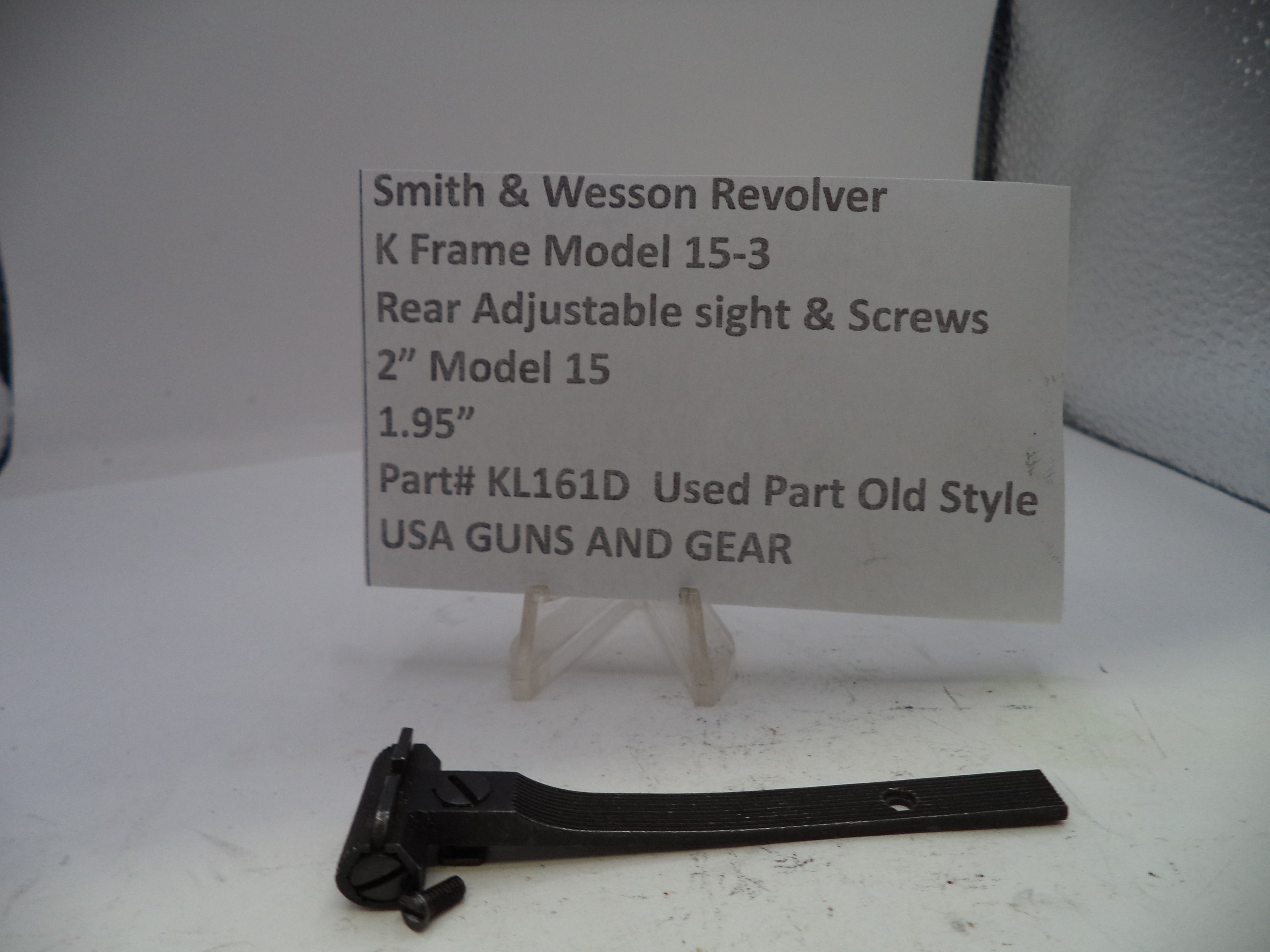 Smith & Wesson revolver sight and screws on a white background with a label.