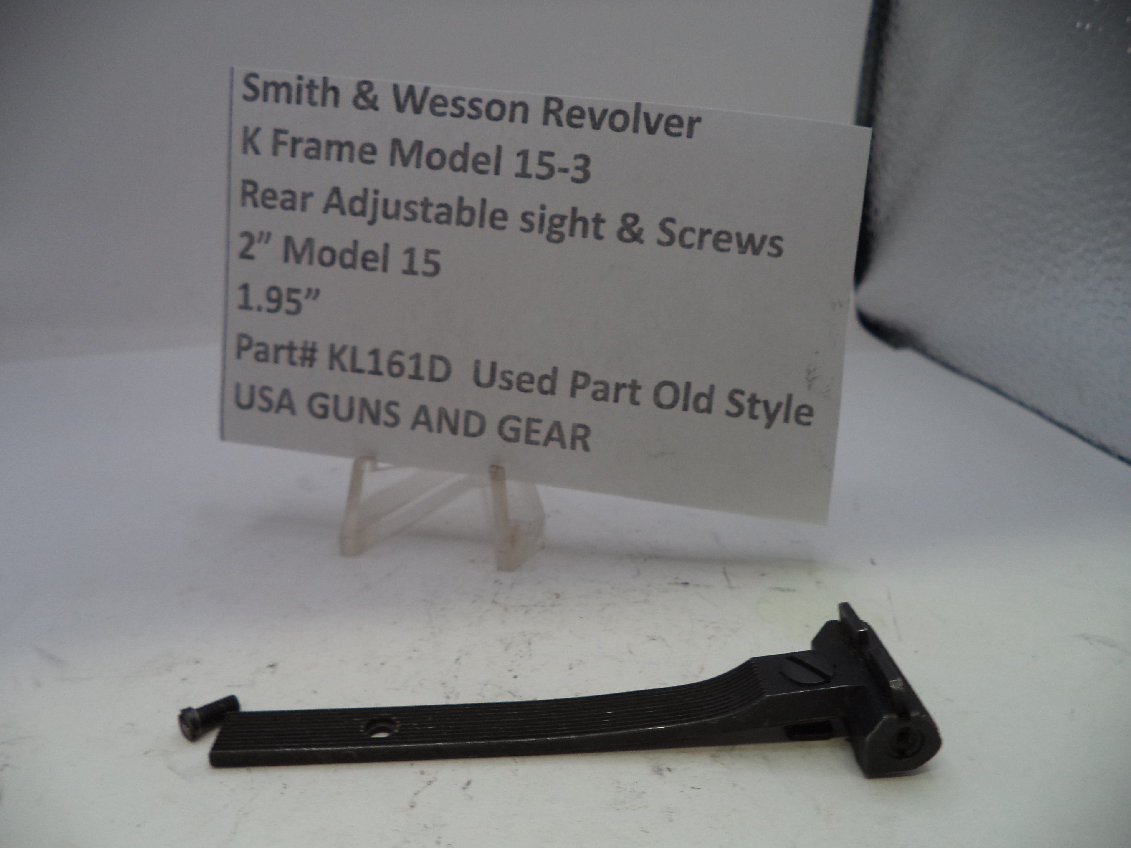 Smith & Wesson revolver sight and screws on a white background with a label.