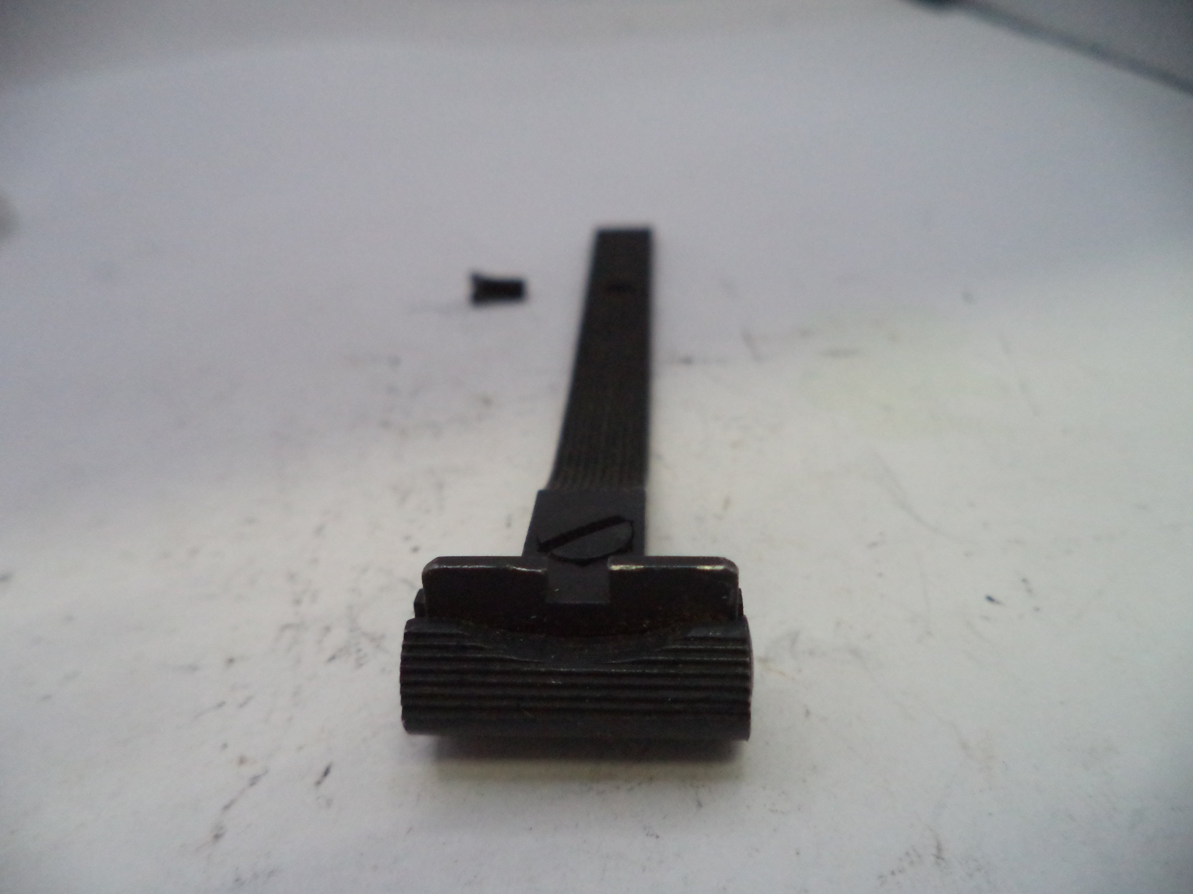 Black metal component on a white surface